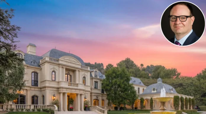 Adrian Wojnarowski House Tour: Inside the ESPN Legend’s Luxurious Home A large, luxurious French château-style mansion with a central dome and manicured front gardens under a warm sunset sky, featuring text overlaid at the bottom reading "Adrian Wojnarowski House"