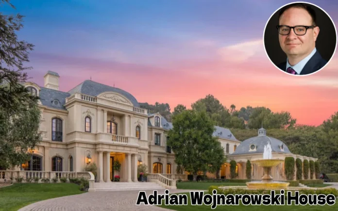Adrian Wojnarowski House Tour A large, luxurious French château-style mansion with a central dome and manicured front gardens under a warm sunset sky, featuring text overlaid at the bottom reading