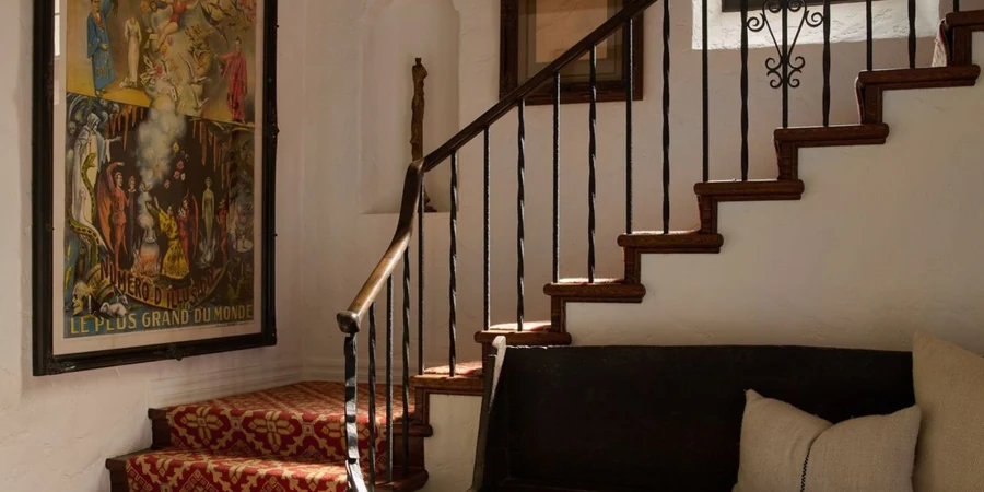 Tiled foyer and carved staircase with stained glass inside the historic Seyler House