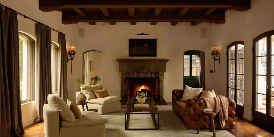 Living room inside the Seyler House with carved wood beams, hand painted ceilings and a stone fireplace