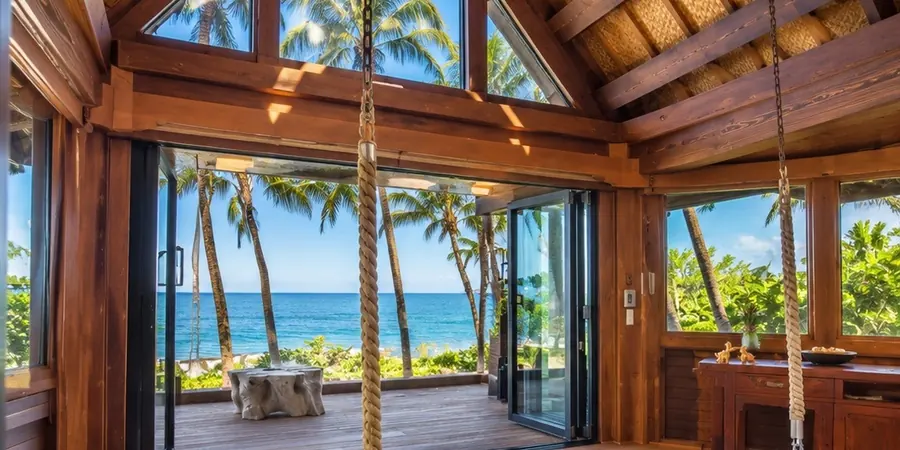 Primary Suite With Swinging Bed and Ocean Deck Primary suite with a rope hung swinging bed, wood beams and glass doors to a deck over the sand.
