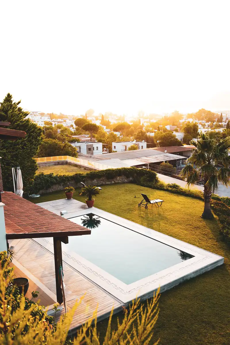 The Ranch That Came Back Off the Market in Three Months 2 A pool with manicured lawns at a ranch-style home