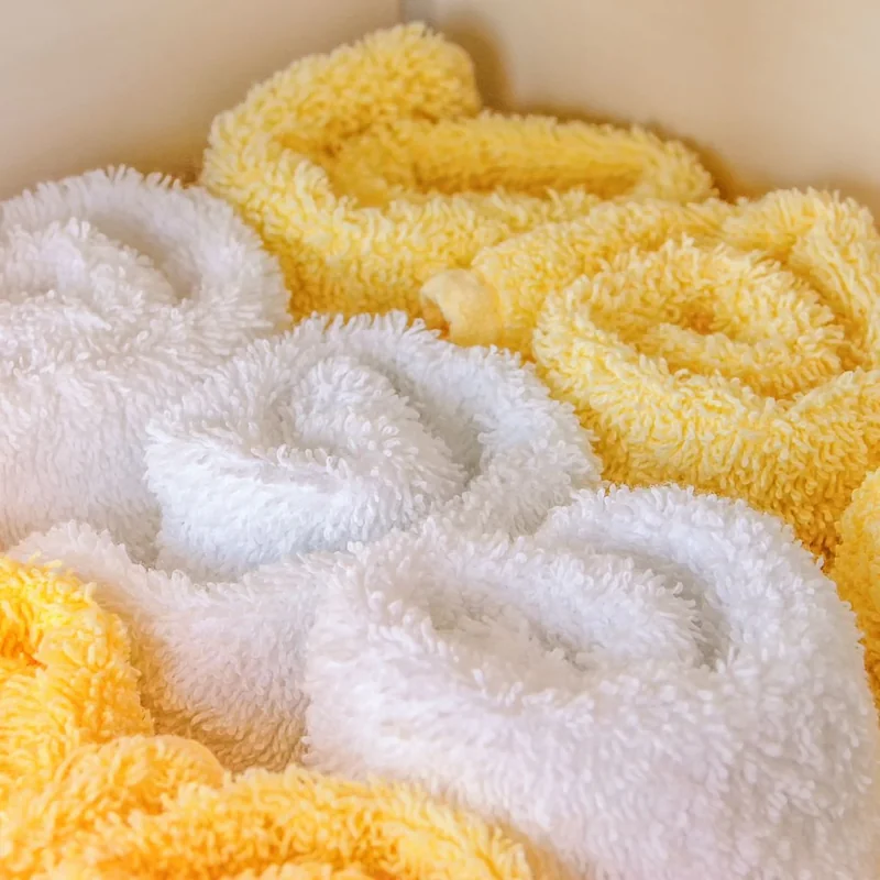 A Small Room, Dressed for December, That Still Works Every Morning 7 Rolled white and pale yellow towels grouped together