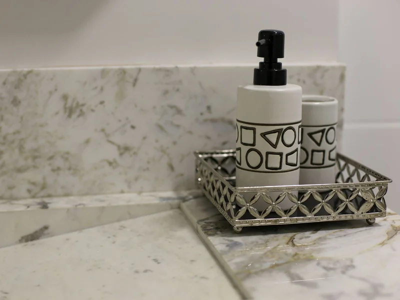 A Small Room, Dressed for December, That Still Works Every Morning 4 Soap dispenser and tumbler on a metal tray beside a marble counter