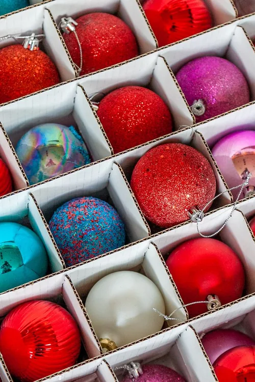 Christmas ornaments packed in individual compartments of a divided storage box
