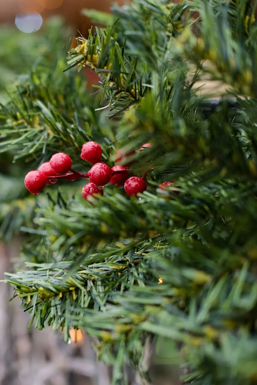 Close-up of a Christmas mantel garland with red berries on evergreen