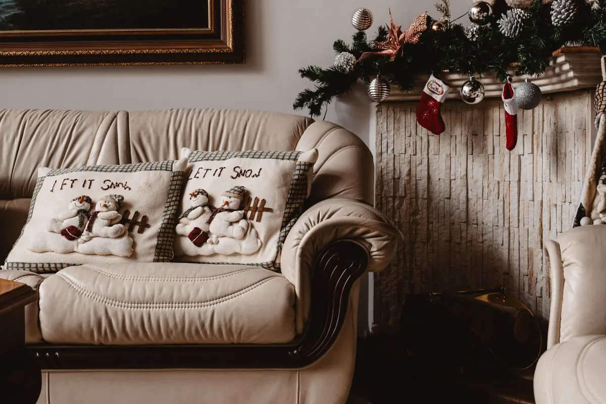 A Festive Small Room That Still Works for Sitting, Walking and Gathering 4 Sofa with festive snowman cushions and a clear seat at Christmas