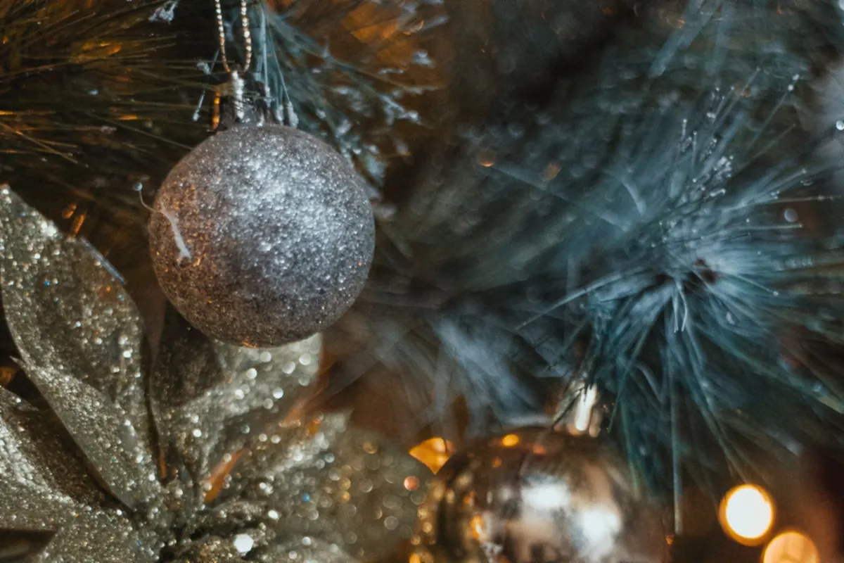 A Festive Small Room That Still Works for Sitting, Walking and Gathering 5 Mirrored and metallic Christmas ornaments catching warm tree light