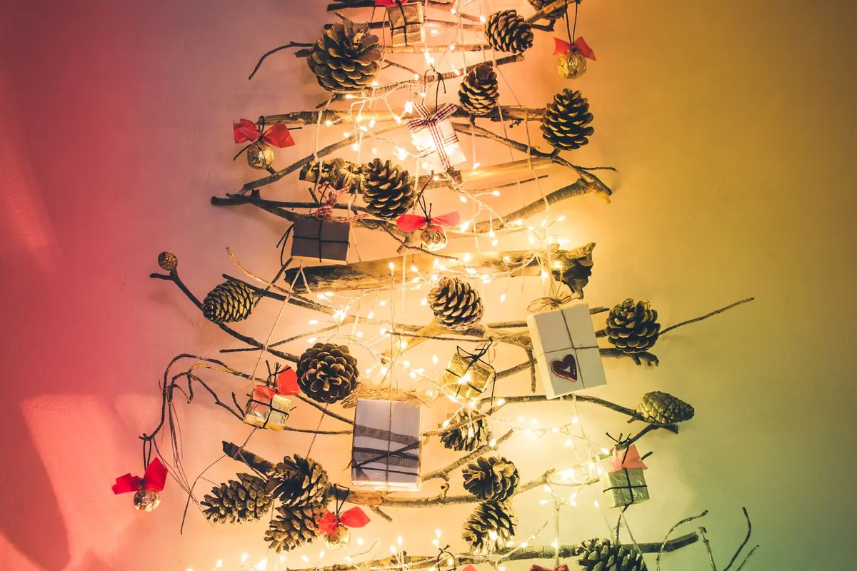 A Festive Small Room That Still Works for Sitting, Walking and Gathering 2 Wall Christmas tree made with branches, pinecones and warm fairy lights